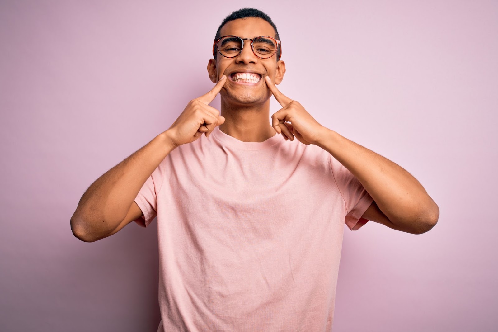 Image of a person smiling with bright white teeth, showcasing the benefits of maintaining whiter teeth through teeth whitening treatments.