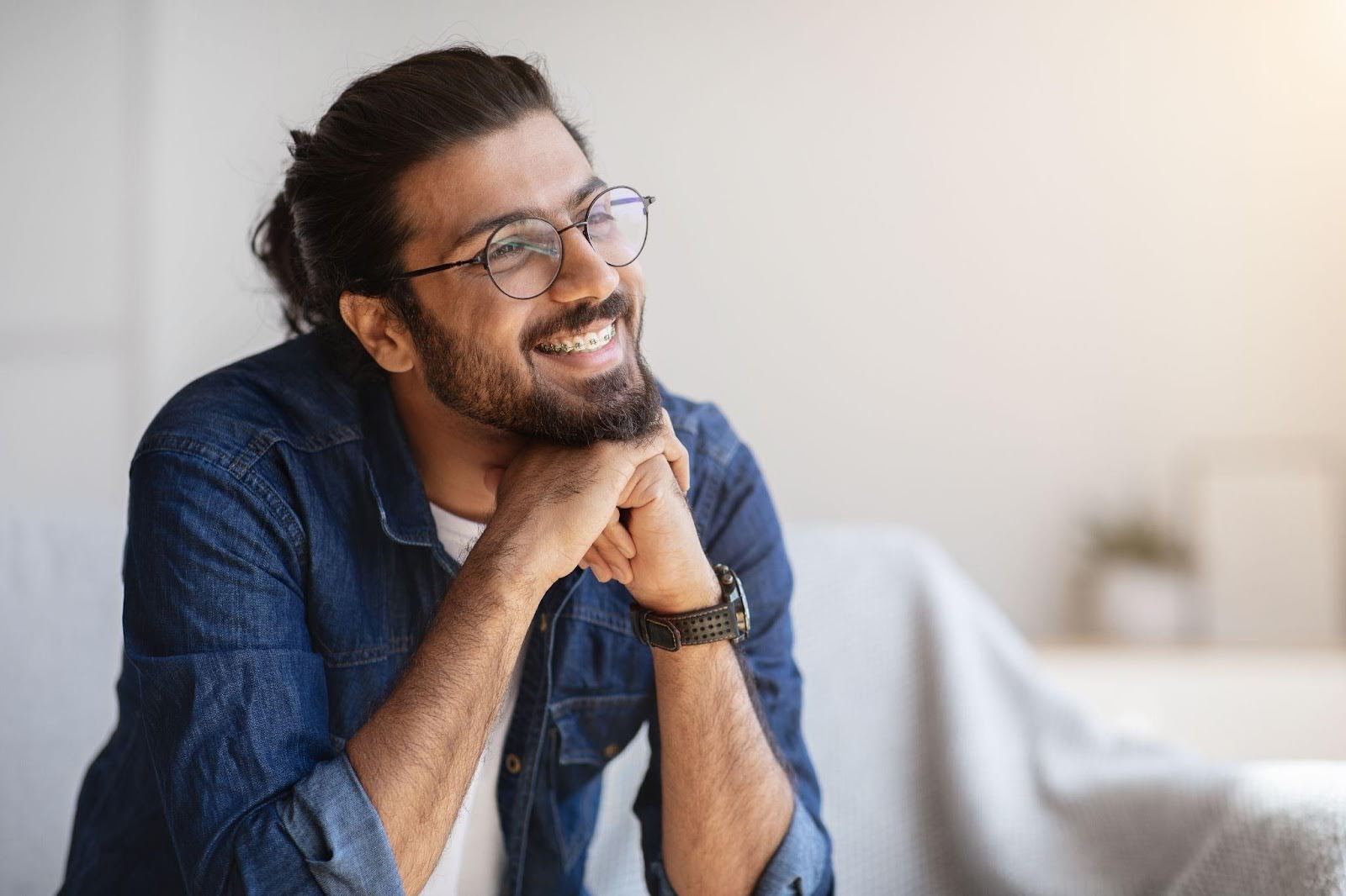 A smiling man with glasses and a beard, exuding warmth and friendliness