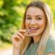 A woman demonstrating proper dental care by holding a toothbrush in her mouth